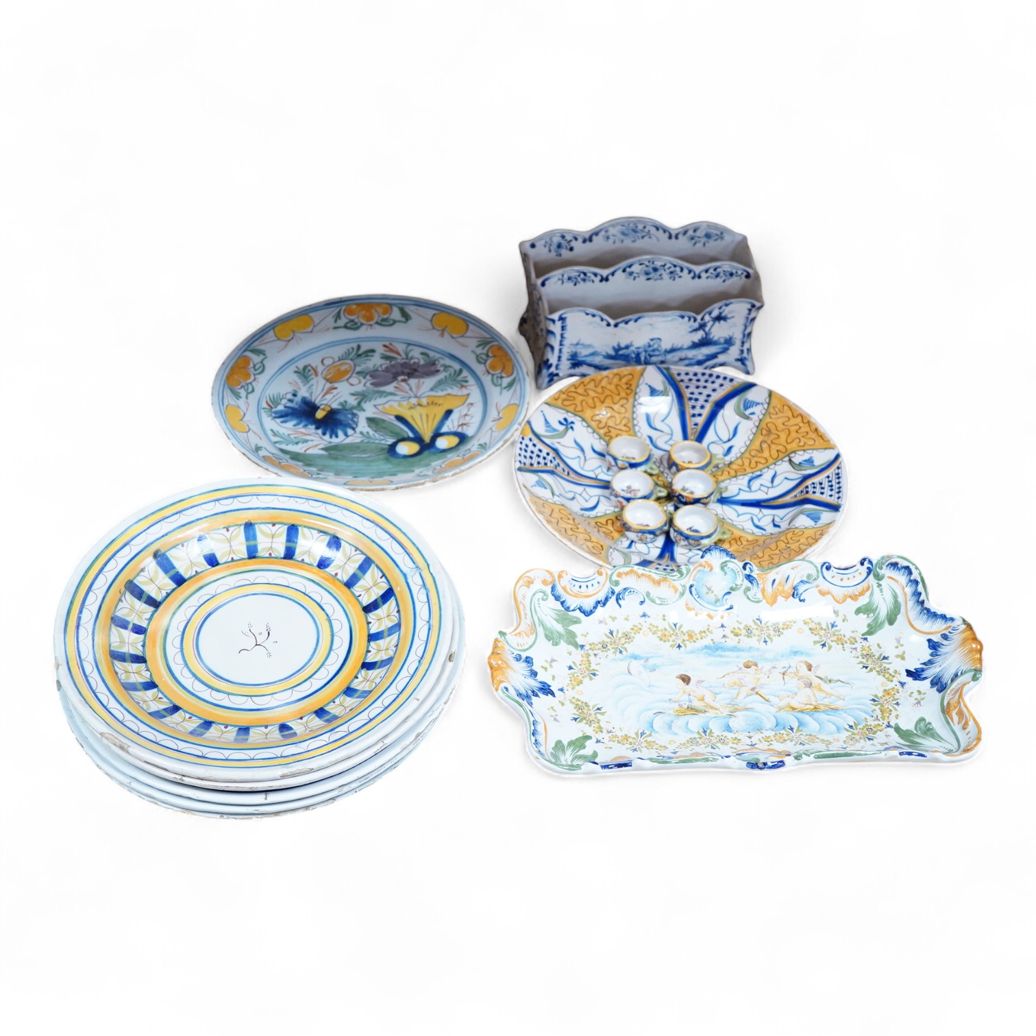 Two 18th century Delft polychrome chargers, five other faience chargers, a rectangular 19th century French faience dish and a blue and white letter rack